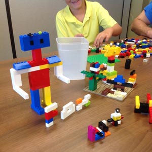 Children building creations with LEGOs