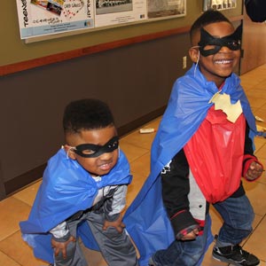 Two young children with superhero costumes